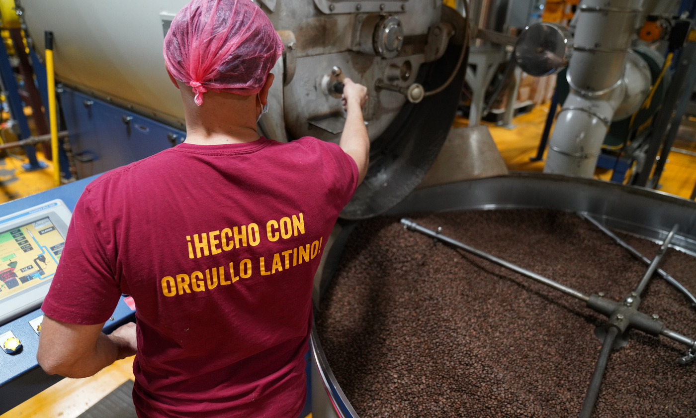 Man wearing Mayorga Coffee T-shirt that says the slogan "hecho con orgullo latino"