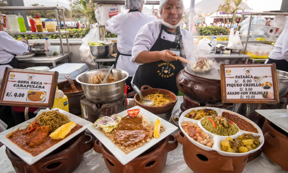 Peruvian woman selling meals at a market out of giant steaming pots. Plates of lomo and dishes of potatoes and olives are laid out in front of her