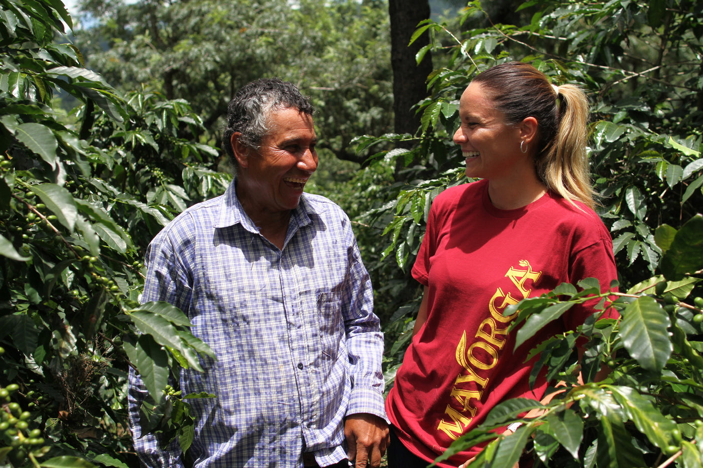 Mayorga coffee employee chats with coffee farmer in Central American coffee farm