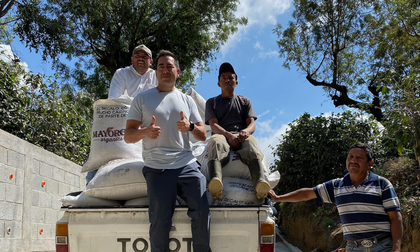Martin Mayorga with three coffee farmers and sacks of Mayorga coffee beans in Latin America
