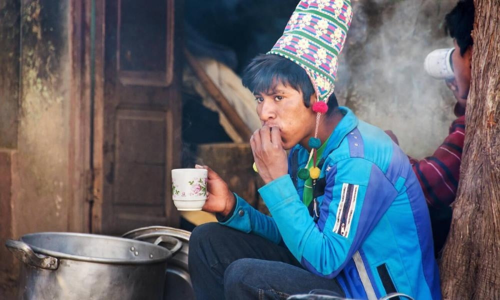 A young boy enjoys hot cocoa in Central America