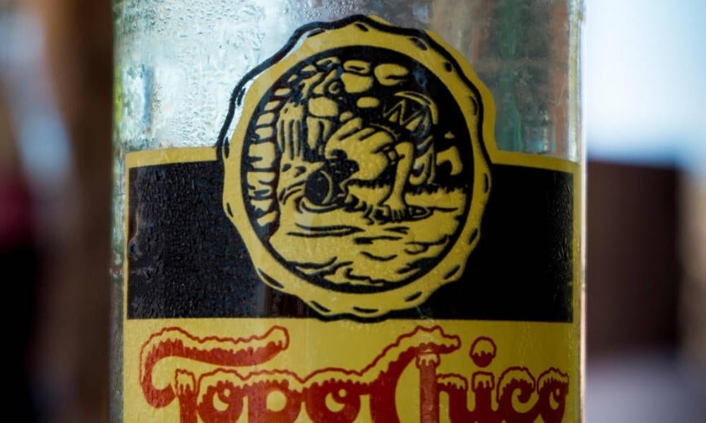 close up of the logo on a bottle of Topo Chico sparkling water
