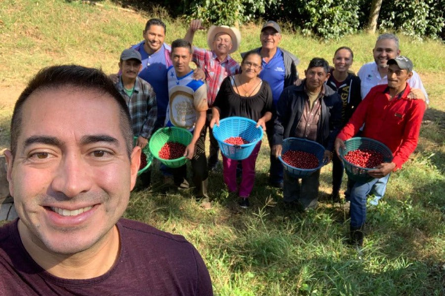 Martin Mayorga with a team of coffee farmers, both men and women, on a farm in Latin America