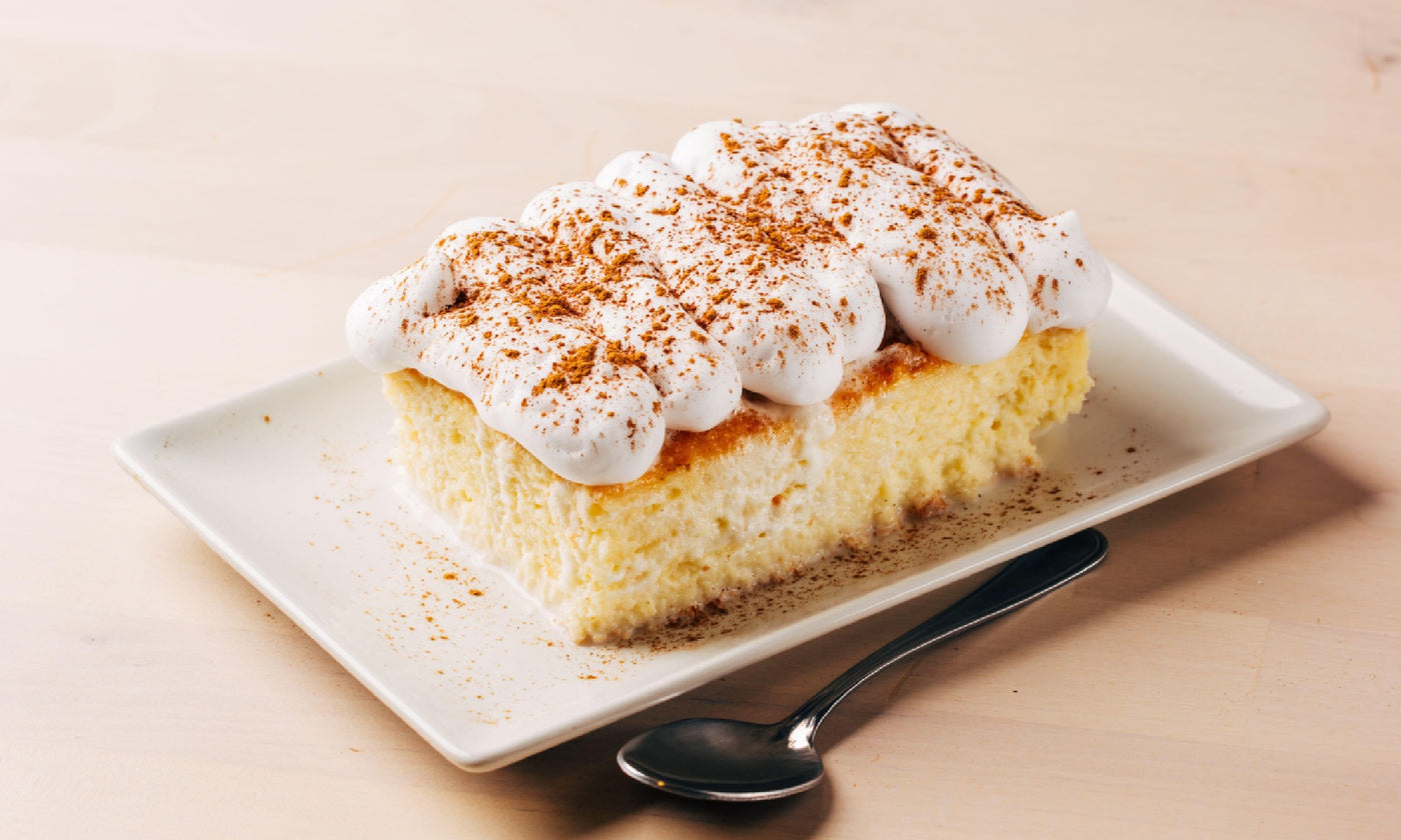 A plate of tres leches dessert