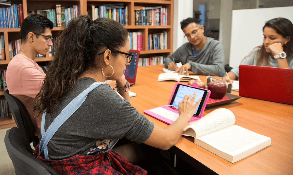 4 Latinx students studying in a college library
